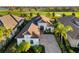 Beautiful single-story home with a tile roof, arched entry, and mature landscaping at 15520 Castle Park Ter, Lakewood Ranch, FL 34202