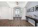 Bright foyer with wood-look tile flooring, soaring ceilings, arched doorways, and natural light at 15520 Castle Park Ter, Lakewood Ranch, FL 34202
