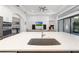 Open concept kitchen and living room with large kitchen island and quartz countertop at 15520 Castle Park Ter, Lakewood Ranch, FL 34202