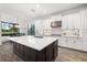 Modern kitchen with a large island, stainless steel appliances, and sleek white cabinetry at 15520 Castle Park Ter, Lakewood Ranch, FL 34202