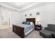Comfortable main bedroom with a dark wood bed frame, soft carpet, and a large window at 15520 Castle Park Ter, Lakewood Ranch, FL 34202