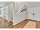Bright foyer featuring hardwood floors, staircase, and double door entry at 1705 Wharf Rd, Sarasota, FL 34231