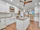 Bright kitchen features white cabinets, an island, stainless steel appliances, and hardwood flooring at 1705 Wharf Rd, Sarasota, FL 34231