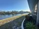 Waterfront backyard with lawn sloping to a lake at 1842 Country Meadows Ct, Sarasota, FL 34235