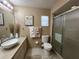 Bathroom with a modern vanity, sleek sink, walk-in shower, and a large mirror with great lighting at 1842 Country Meadows Ct, Sarasota, FL 34235