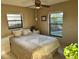 Cozy bedroom with natural light, a neutral color scheme, and serene outdoor views from the windows at 1842 Country Meadows Ct, Sarasota, FL 34235