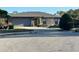 Charming single-story home with stone accents, a well-maintained lawn, and an attached two-car garage at 1842 Country Meadows Ct, Sarasota, FL 34235