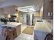 Well-lit kitchen with stainless steel appliances, ample counter space, and a breakfast bar with seating at 1842 Country Meadows Ct, Sarasota, FL 34235