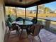 Outdoor dining set on patio overlooking a lake at 1842 Country Meadows Ct, Sarasota, FL 34235