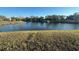 Lakeside view offers serenity and picturesque backdrop, enhancing the community's natural beauty at 1842 Country Meadows Ct, Sarasota, FL 34235