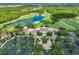 Stunning aerial view of a community clubhouse with a golf course and serene lakes at 19424 Ganton Ave, Lakewood Ranch, FL 34202