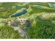 Breathtaking aerial view of a community featuring a golf course, lakes, and beautiful landscaping at 19424 Ganton Ave, Lakewood Ranch, FL 34202