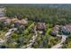 Aerial view of a luxurious estate with a tile roof, lush landscaping, and a private driveway at 19424 Ganton Ave, Lakewood Ranch, FL 34202