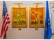 This image features two framed golf art pieces with the USA and Euro flag flanking each side at 19424 Ganton Ave, Lakewood Ranch, FL 34202