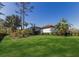 Expansive backyard with well-maintained lawn and tropical landscaping for a serene outdoor living space at 19424 Ganton Ave, Lakewood Ranch, FL 34202