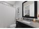 Bathroom featuring a vanity with dark wood cabinets, a framed mirror, and a shower with a white curtain at 19424 Ganton Ave, Lakewood Ranch, FL 34202