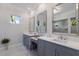 Elegant bathroom vanity with framed mirrors, white marble countertops and modern fixtures at 19424 Ganton Ave, Lakewood Ranch, FL 34202