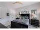 Cozy bedroom featuring a black bed frame, golf decor, and neutral-toned walls at 19424 Ganton Ave, Lakewood Ranch, FL 34202