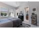 Spacious bedroom with a gray bed, three windows for natural light, and an ensuite bathroom at 19424 Ganton Ave, Lakewood Ranch, FL 34202