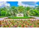 Golf clubhouse sign surrounded by vibrant flowers and manicured landscaping at 19424 Ganton Ave, Lakewood Ranch, FL 34202