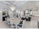 Open-concept dining room with an elegant chandelier and views into a modern kitchen at 19424 Ganton Ave, Lakewood Ranch, FL 34202
