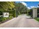 Elegant entrance to a golf club and residences with a stone-paved driveway and manicured greenery at 19424 Ganton Ave, Lakewood Ranch, FL 34202