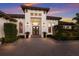 Elegant entrance with a modern door, stylish lighting, and manicured greenery enhancing the home's curb appeal at 19424 Ganton Ave, Lakewood Ranch, FL 34202