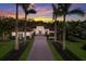 Elegant home with a beautiful red brick driveway, lush landscaping, and well-maintained lawn at 19424 Ganton Ave, Lakewood Ranch, FL 34202