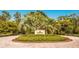 Beautiful Golf Clubhouse sign surrounded by manicured landscaping with flowers and palm trees on a brick roundabout at 19424 Ganton Ave, Lakewood Ranch, FL 34202