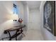 Bright hallway with elegant decor, featuring a stylish table with flowers and striking wall art at 19424 Ganton Ave, Lakewood Ranch, FL 34202