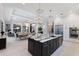 Open-concept kitchen featuring a large island with a waterfall countertop and stainless steel appliances at 19424 Ganton Ave, Lakewood Ranch, FL 34202