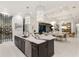 Spacious kitchen flows to dining area, featuring a large island with seating and modern lighting at 19424 Ganton Ave, Lakewood Ranch, FL 34202