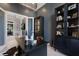 Well-lit home office boasts custom cabinetry and serene views, creating a productive workspace at 19424 Ganton Ave, Lakewood Ranch, FL 34202