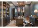 Stylish home office with a large desk, elegant lighting, and views of the lush landscape at 19424 Ganton Ave, Lakewood Ranch, FL 34202