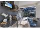 Outdoor kitchen has stainless appliances, granite countertops, and a picturesque view of the screened pool at 19424 Ganton Ave, Lakewood Ranch, FL 34202