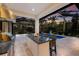 Well-equipped outdoor kitchen with bar seating overlooking the screened pool and scenic backyard at 19424 Ganton Ave, Lakewood Ranch, FL 34202
