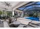 Inviting outdoor living area with pool, lounge seating, and a fully equipped kitchen for entertaining at 19424 Ganton Ave, Lakewood Ranch, FL 34202
