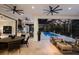 Spacious outdoor living area with dining, seating, and kitchen overlooking screened pool and backyard at 19424 Ganton Ave, Lakewood Ranch, FL 34202