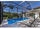 Beautiful screened pool with sun loungers and lush landscaping, perfect for relaxation and outdoor entertainment at 19424 Ganton Ave, Lakewood Ranch, FL 34202