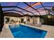 Beautiful screened pool area with a covered outdoor kitchen and dining and lounge areas, perfect for entertaining at 19424 Ganton Ave, Lakewood Ranch, FL 34202