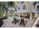 Backyard with a private pool, lounge chairs, and covered outdoor seating area perfect for relaxing and entertaining at 204 66Th Street, Holmes Beach, FL 34217