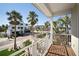 Outdoor balcony offering scenic neighborhood views and overlooking lush tropical palm trees at 204 66Th Street, Holmes Beach, FL 34217