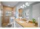 Bathroom featuring a stone walk-in shower, granite countertops, and modern fixtures at 204 66Th Street, Holmes Beach, FL 34217