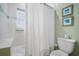 Cozy bathroom featuring a shower-tub combo, a neutral color palette, and a storage shelf at 204 66Th Street, Holmes Beach, FL 34217