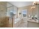 Modern bathroom featuring a glass shower, soaking tub, and double sink vanity with granite countertop at 204 66Th Street, Holmes Beach, FL 34217