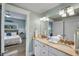 Bright bathroom with double sinks, granite countertops, and an adjacent bedroom at 204 66Th Street, Holmes Beach, FL 34217