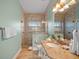 Elegant bathroom featuring a glass shower, granite countertop, and a sink with bronze hardware at 204 66Th Street, Holmes Beach, FL 34217