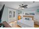 Bright bedroom with a queen bed, wood floors, private balcony access, and stylish decor at 204 66Th Street, Holmes Beach, FL 34217