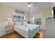 Inviting bedroom features a light blue bed frame, tropical decor, and natural light from two windows at 204 66Th Street, Holmes Beach, FL 34217