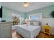 Bright bedroom featuring a white wicker bed, light blue walls, and a charming tropical decor at 204 66Th Street, Holmes Beach, FL 34217